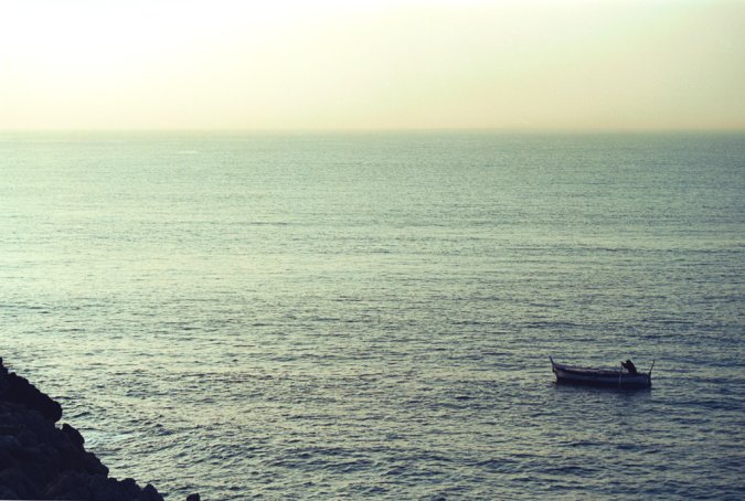 View of rauba capeu at dawn, with a typical fish boat from Nice going back to the harbour