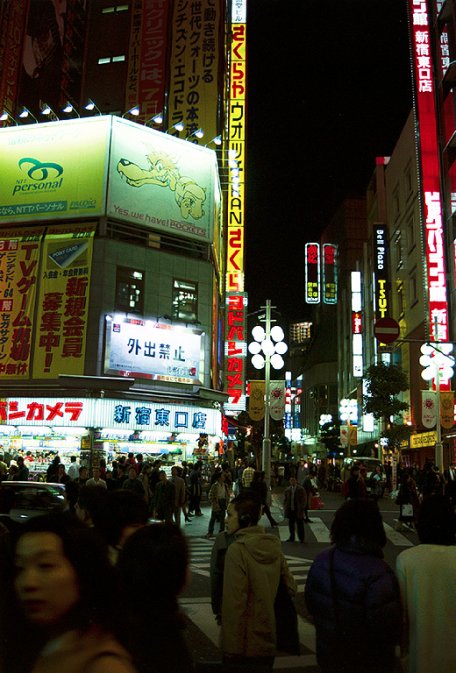 A night view of Shinjuku, with lots of neons, quite crowded