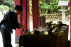 Norio showing me how to use the fountain, in a big temple place, near Kamakura station, I don't remember the name...