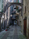 Many little archs keeping houses together, a small street of Isolabona, Italy